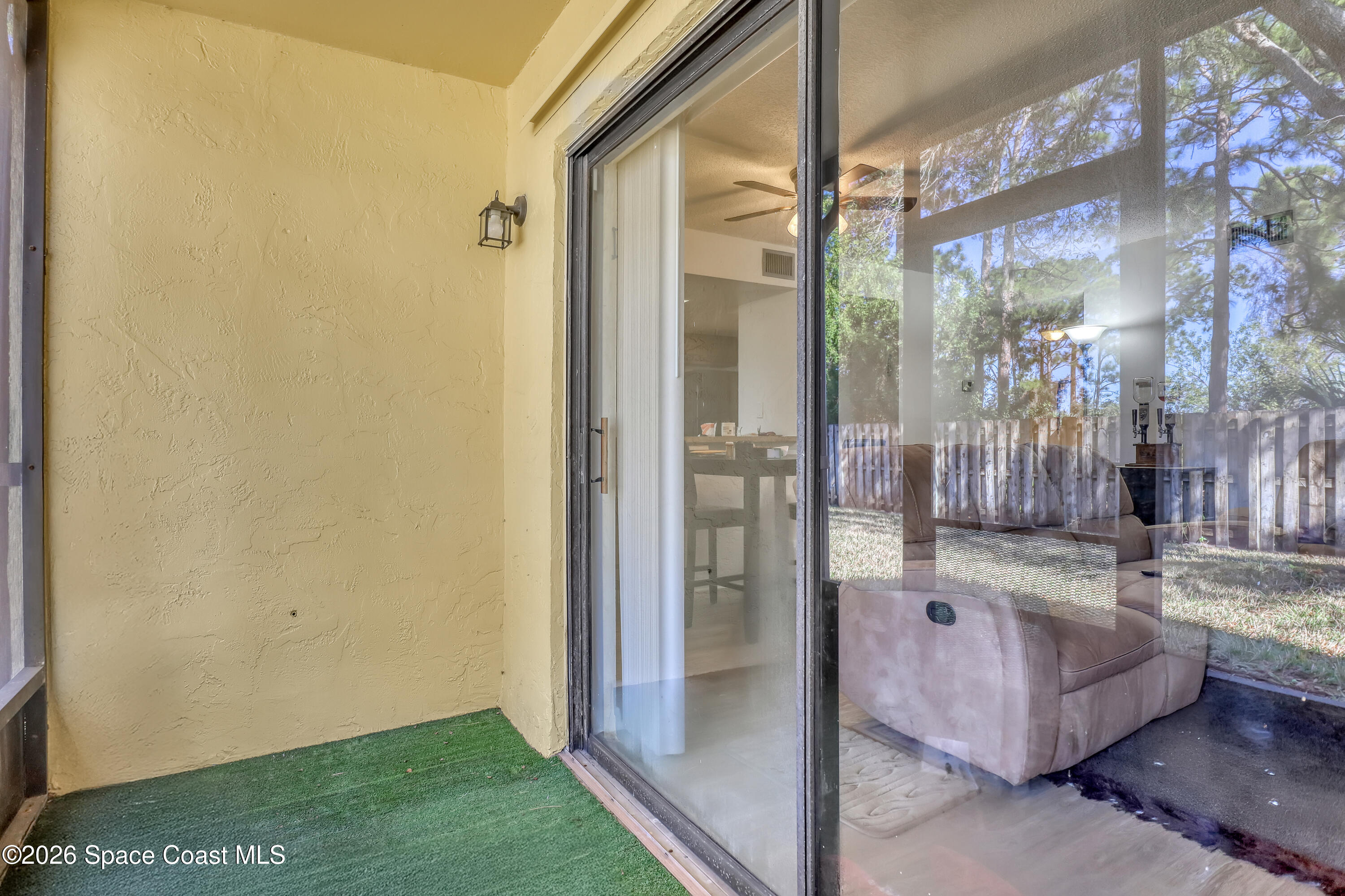 588 North Wickham Road, Unit 51 Melbourne, FL 32935 - Photo 20 of 27 a view of living room kitchen and entryway