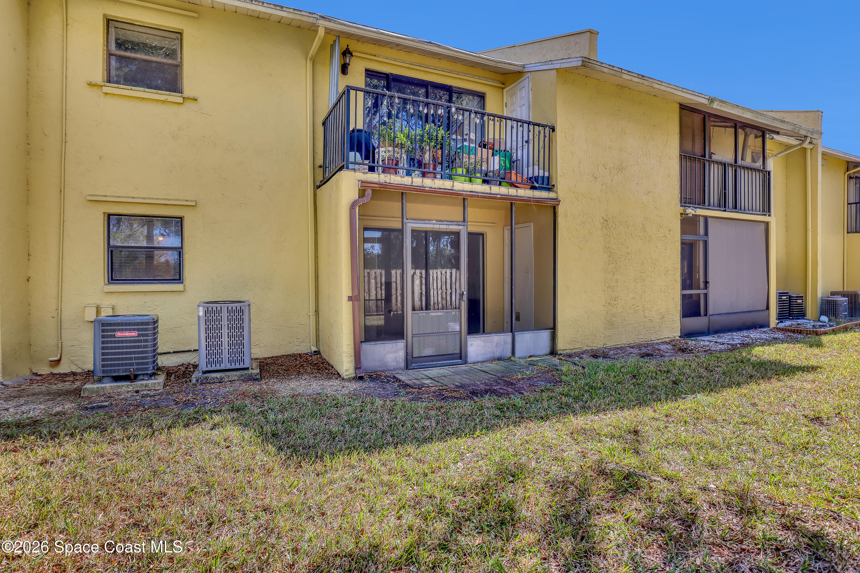 588 North Wickham Road, Unit 51 Melbourne, FL 32935 - Photo 21 of 27 a view of a house with many windows and yard