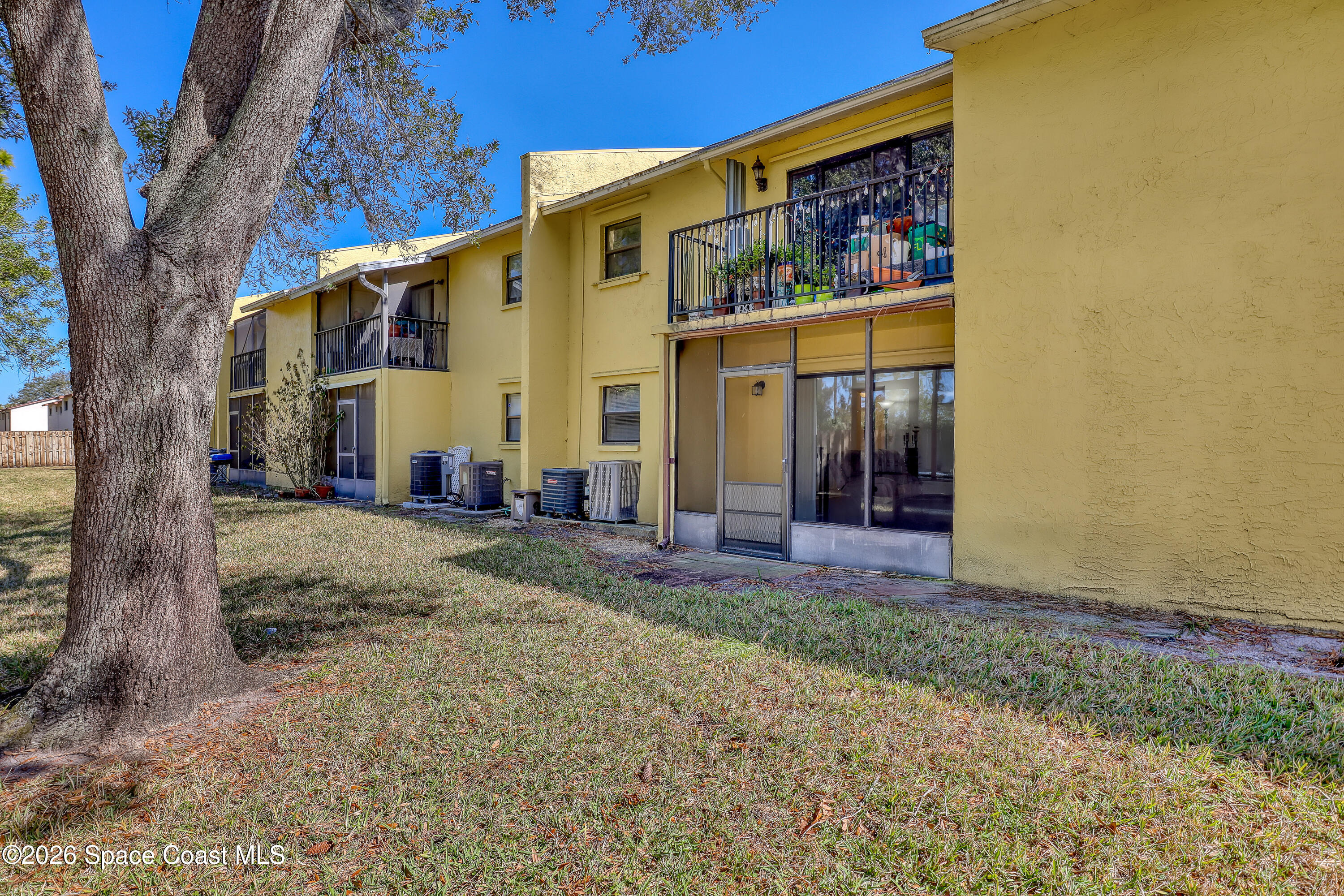 588 North Wickham Road, Unit 51 Melbourne, FL 32935 - Photo 23 of 27 a view of a house with backyard and a tree