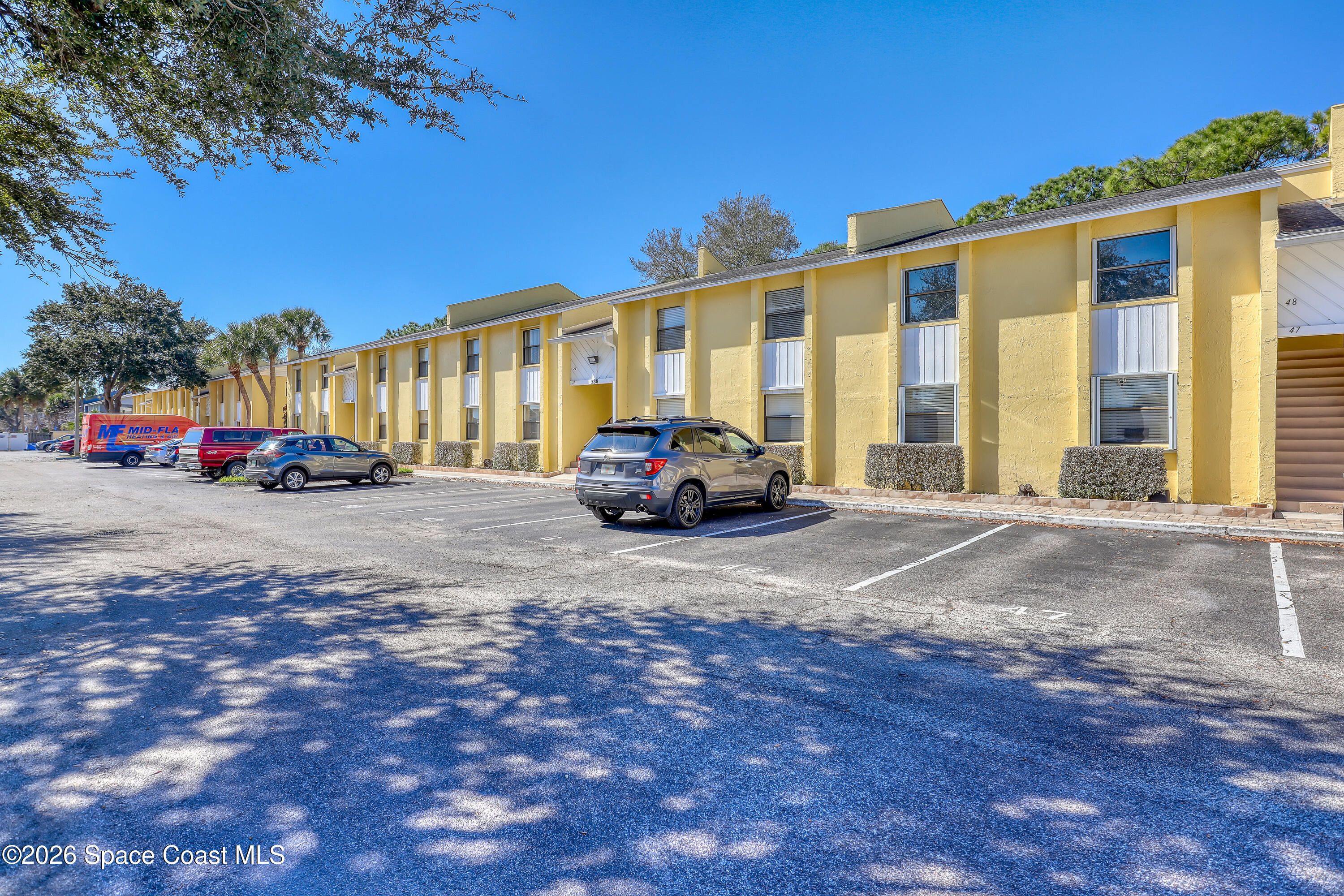 588 North Wickham Road, Unit 51 Melbourne, FL 32935 - Photo 24 of 27 a cars parked in front of a building