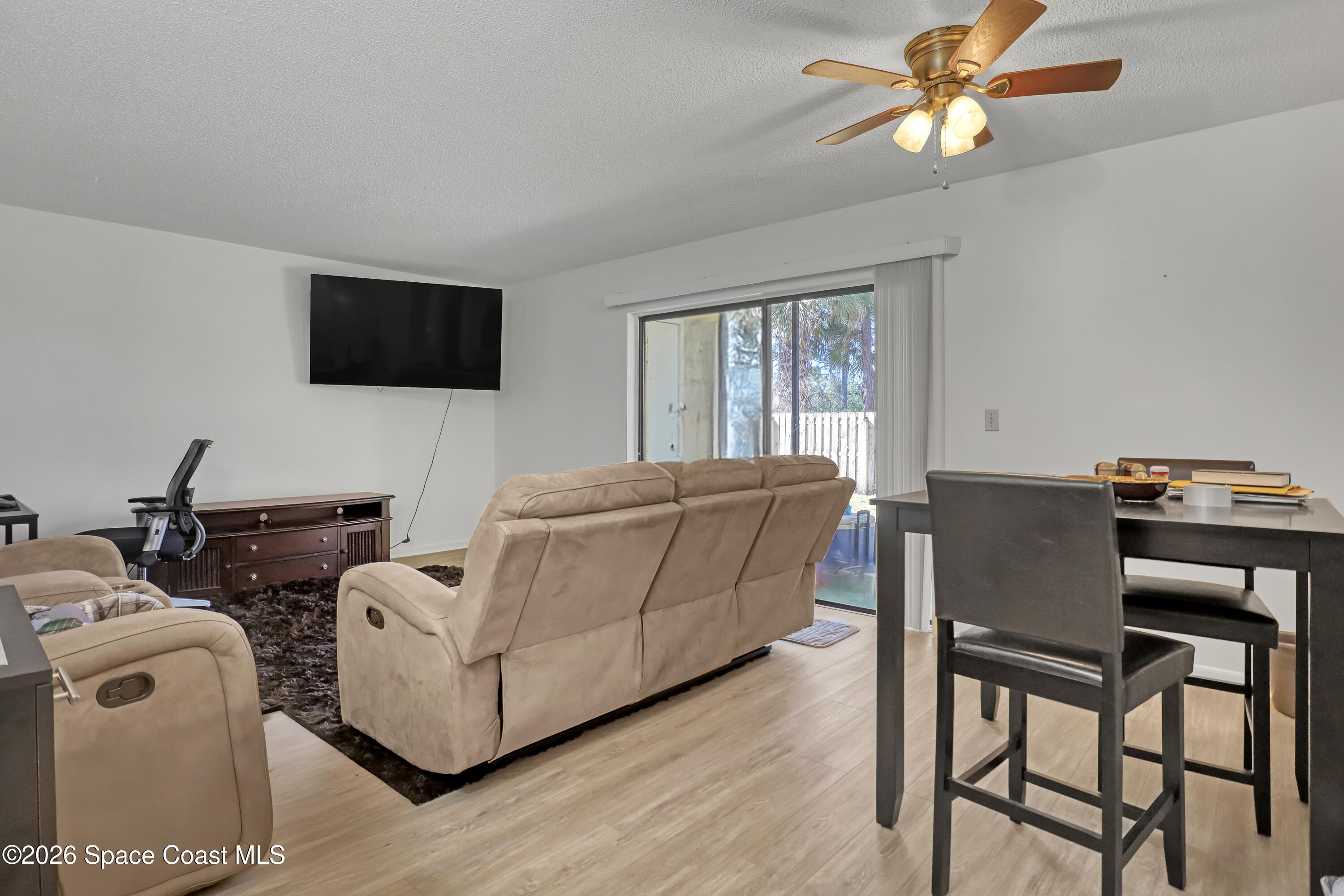 588 North Wickham Road, Unit 51 Melbourne, FL 32935 - Photo 4 of 27 a living room with furniture and a flat screen tv
