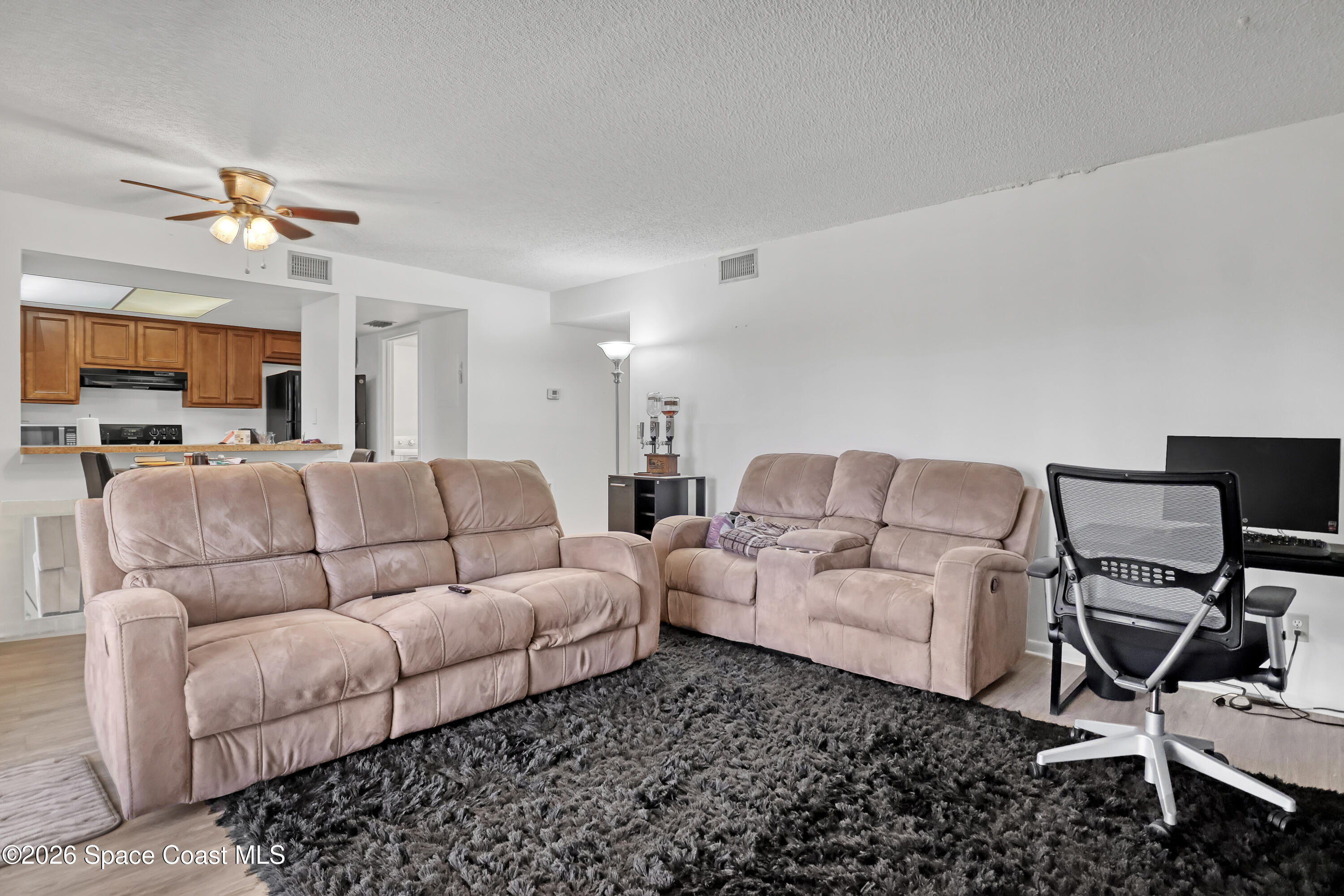 588 North Wickham Road, Unit 51 Melbourne, FL 32935 - Photo 7 of 27 a living room with furniture and a flat screen tv