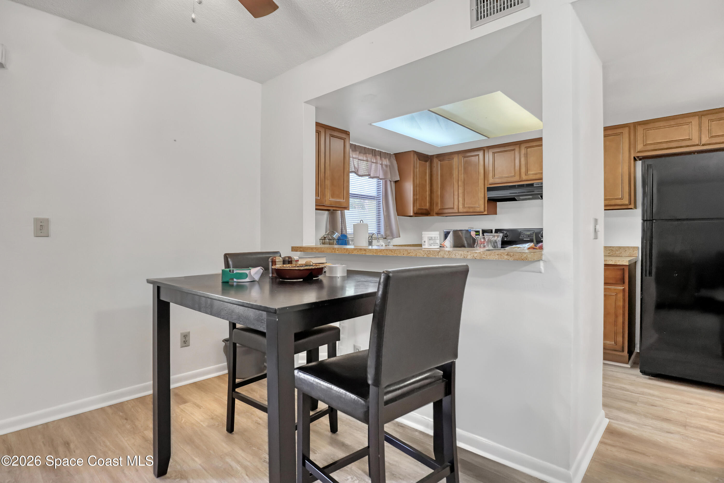 588 North Wickham Road, Unit 51 Melbourne, FL 32935 - Photo 8 of 27 a kitchen with a table and chairs in it