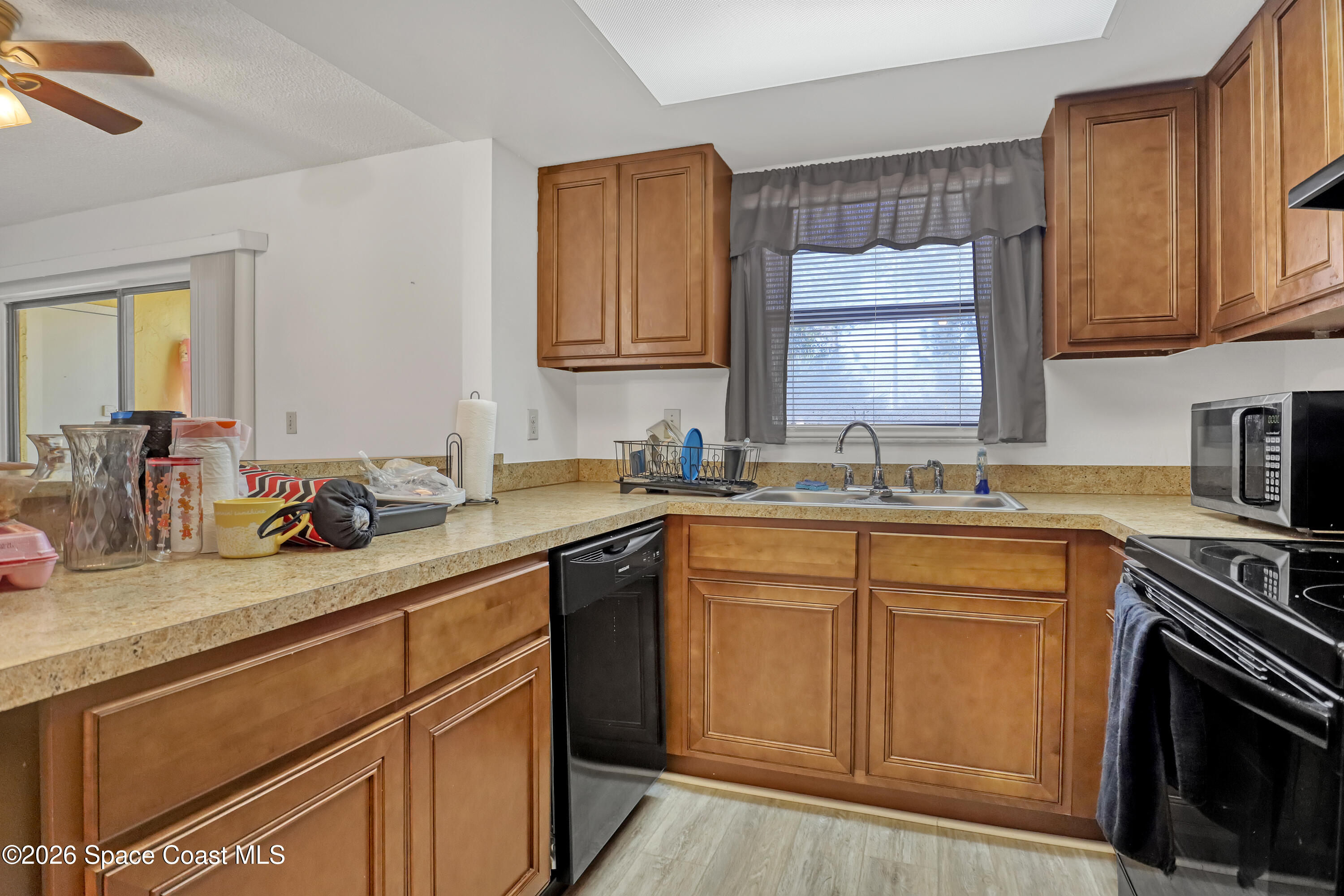 588 North Wickham Road, Unit 51 Melbourne, FL 32935 - Photo 10 of 27 a kitchen with a sink stove and cabinets