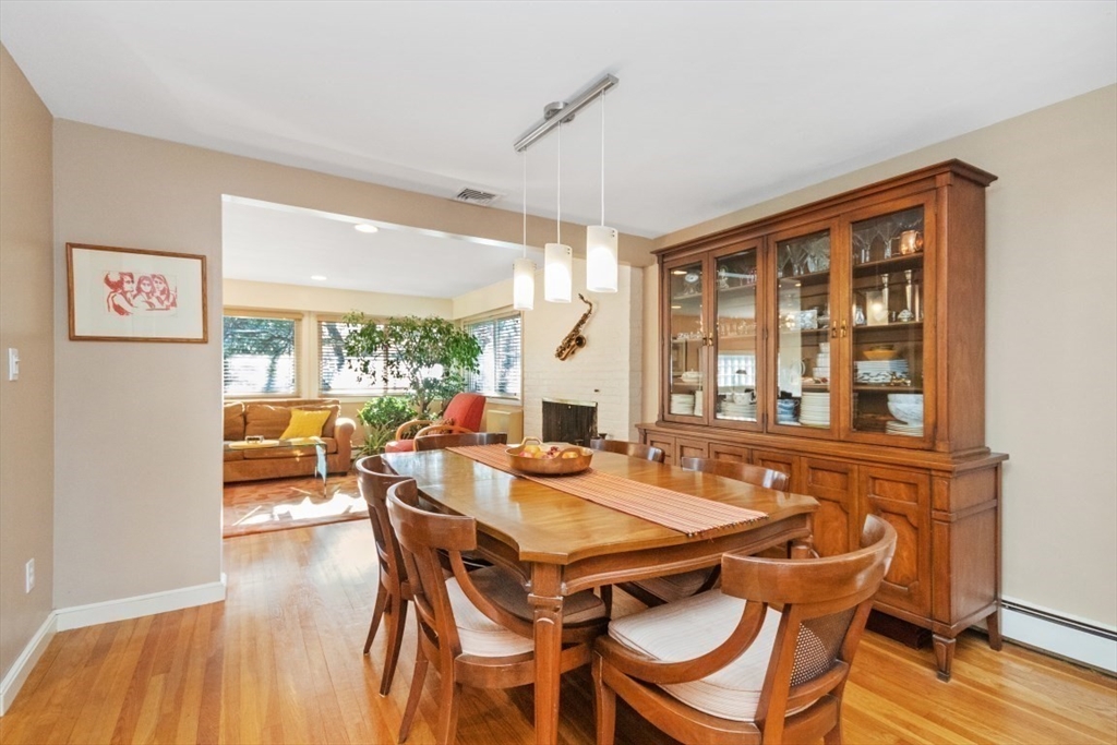 65 Blake Needham, MA 02492 - Photo 5 of 20 a view of a dining room with furniture large windows and wooden floor
