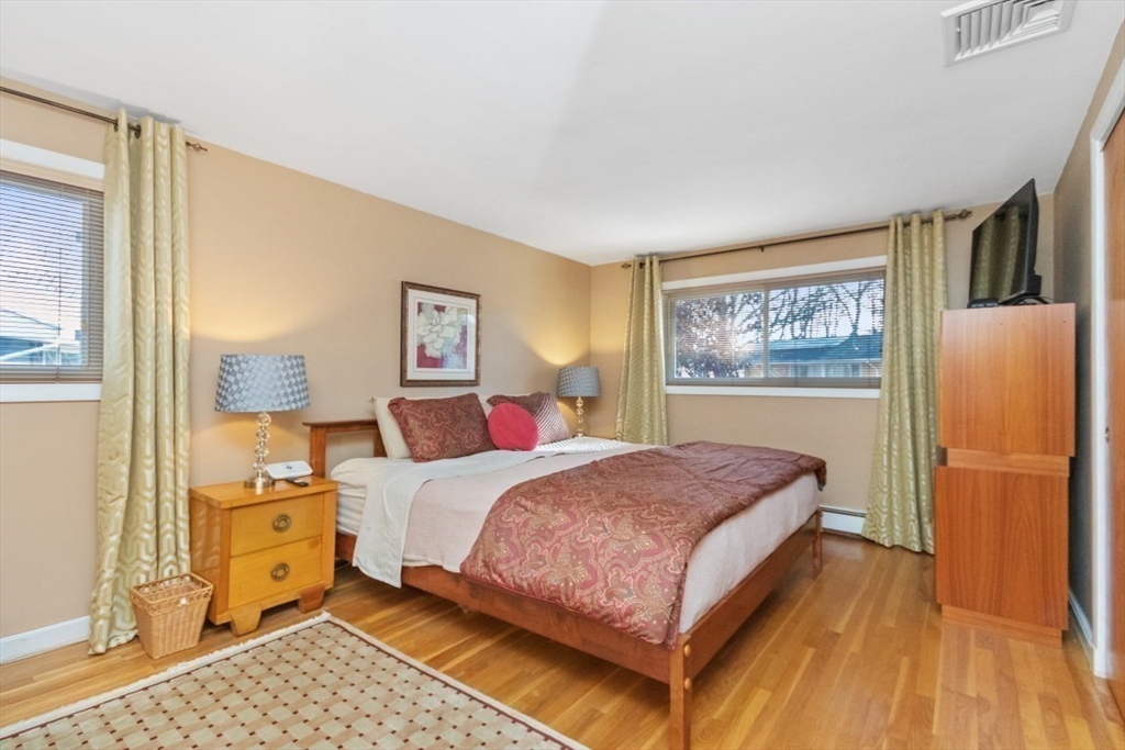 65 Blake Needham, MA 02492 - Photo 9 of 20 a bedroom with a bed and wooden floor