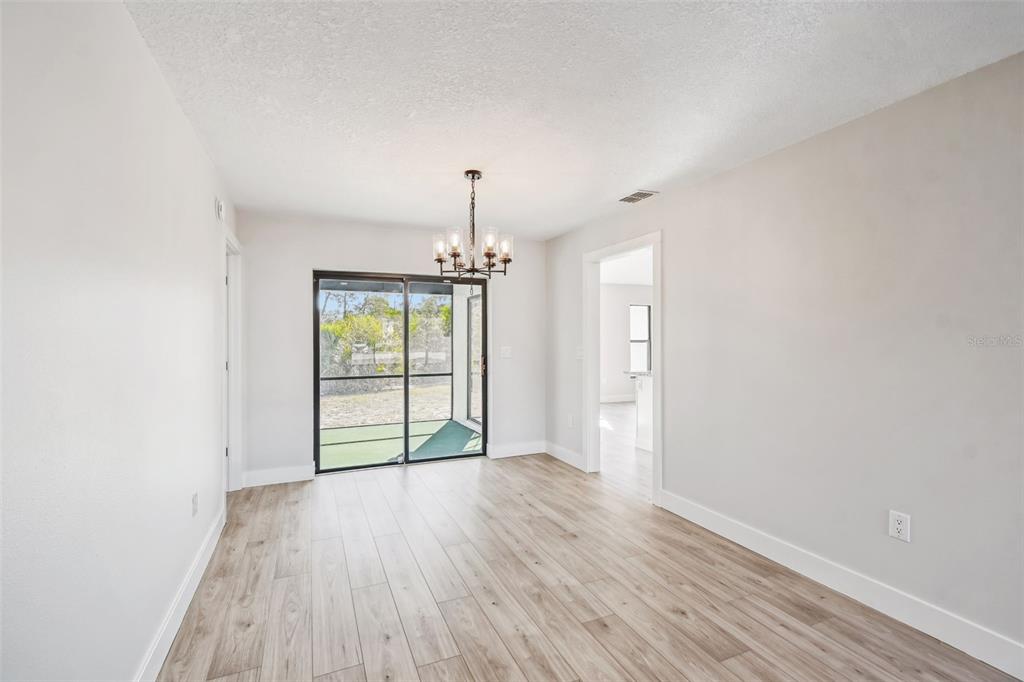 5248 Frost Road Spring Hill, FL 34606 - Photo 14 of 70 wooden floor in an empty room with a window