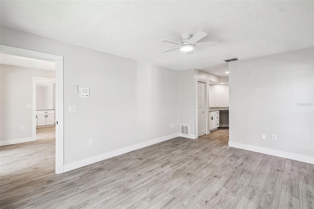 5248 Frost Road Spring Hill, FL 34606 - Photo 18 of 70 an empty room with wooden floor and a ceiling fan