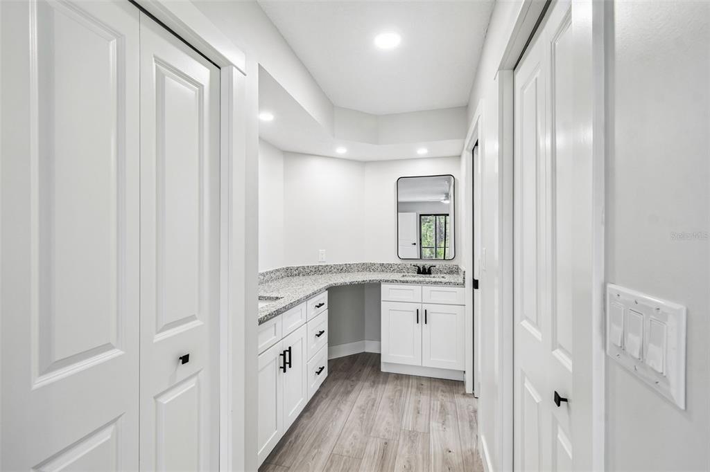 5248 Frost Road Spring Hill, FL 34606 - Photo 20 of 70 a large white kitchen with granite countertop a sink and dishwasher with white cabinets