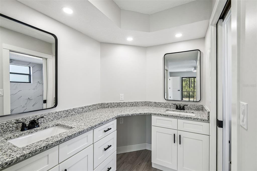 5248 Frost Road Spring Hill, FL 34606 - Photo 21 of 70 a bathroom with a granite countertop sink and a mirror