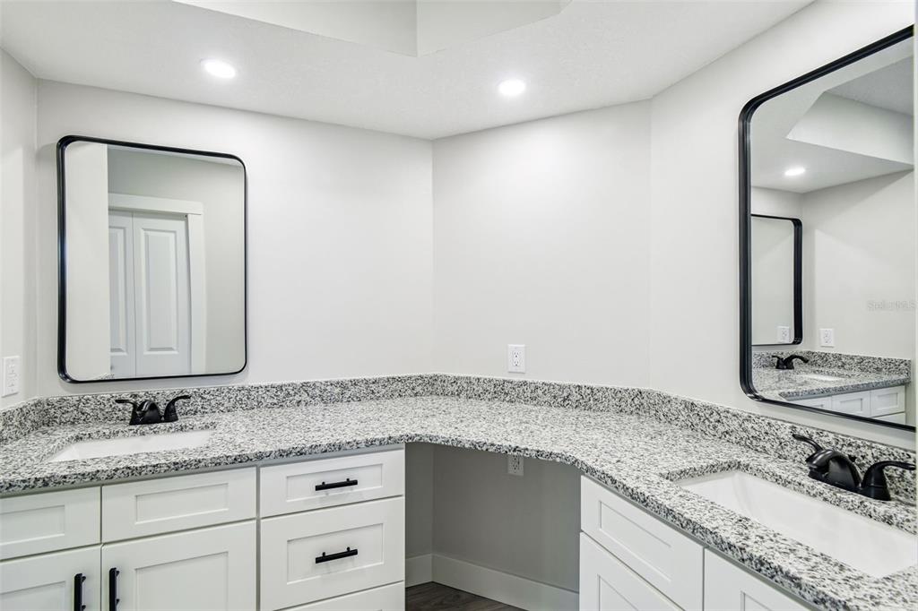 5248 Frost Road Spring Hill, FL 34606 - Photo 22 of 70 a bathroom with a granite countertop sink and a mirror