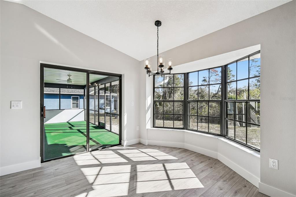 5248 Frost Road Spring Hill, FL 34606 - Photo 37 of 70 a view of an entryway with a floor to ceiling window and wooden floor