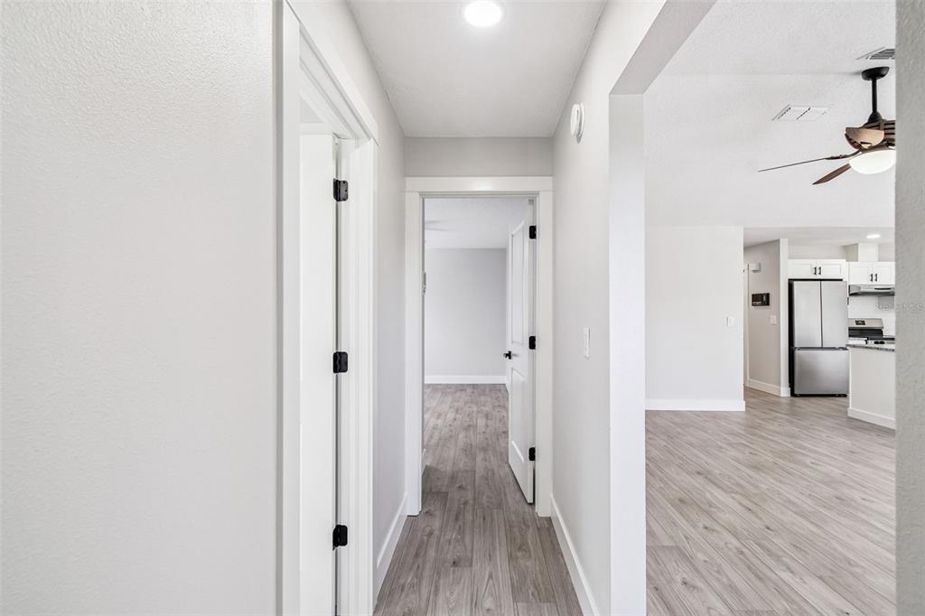 5248 Frost Road Spring Hill, FL 34606 - Photo 47 of 70 a view of a hallway with wooden floor and a bathroom