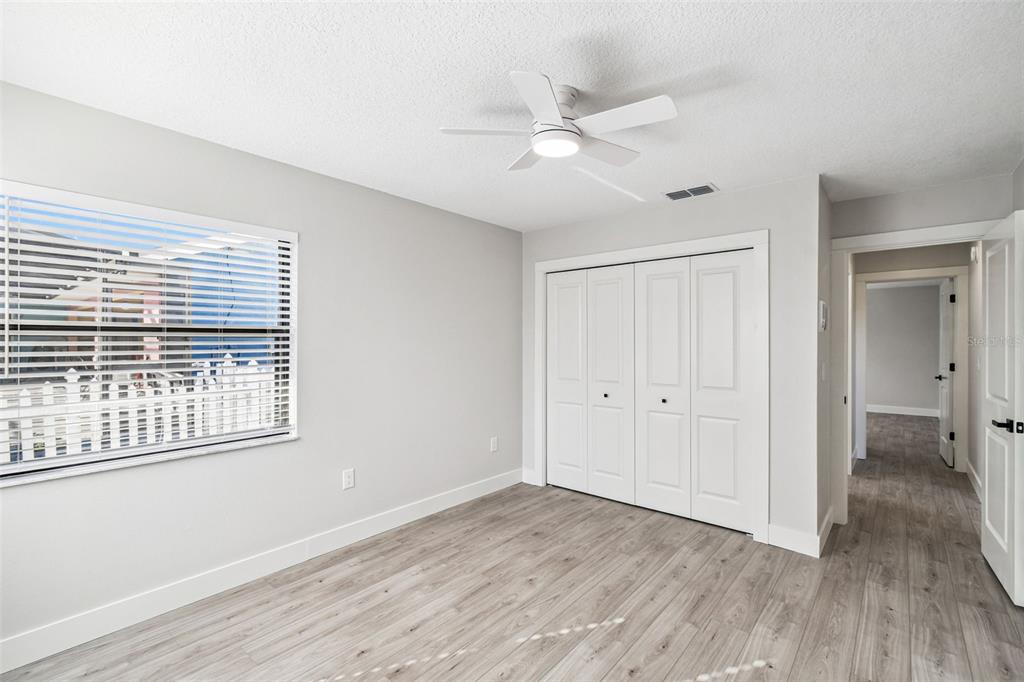 5248 Frost Road Spring Hill, FL 34606 - Photo 52 of 70 a view of an empty room with wooden floor and a window
