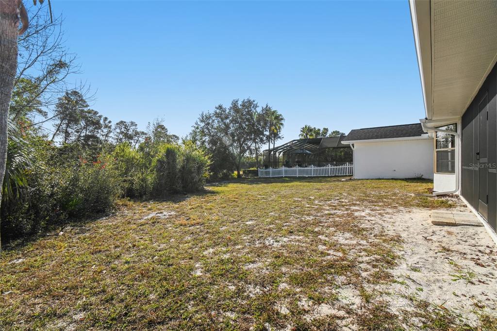 5248 Frost Road Spring Hill, FL 34606 - Photo 57 of 70 a backyard of a house with lots of green space