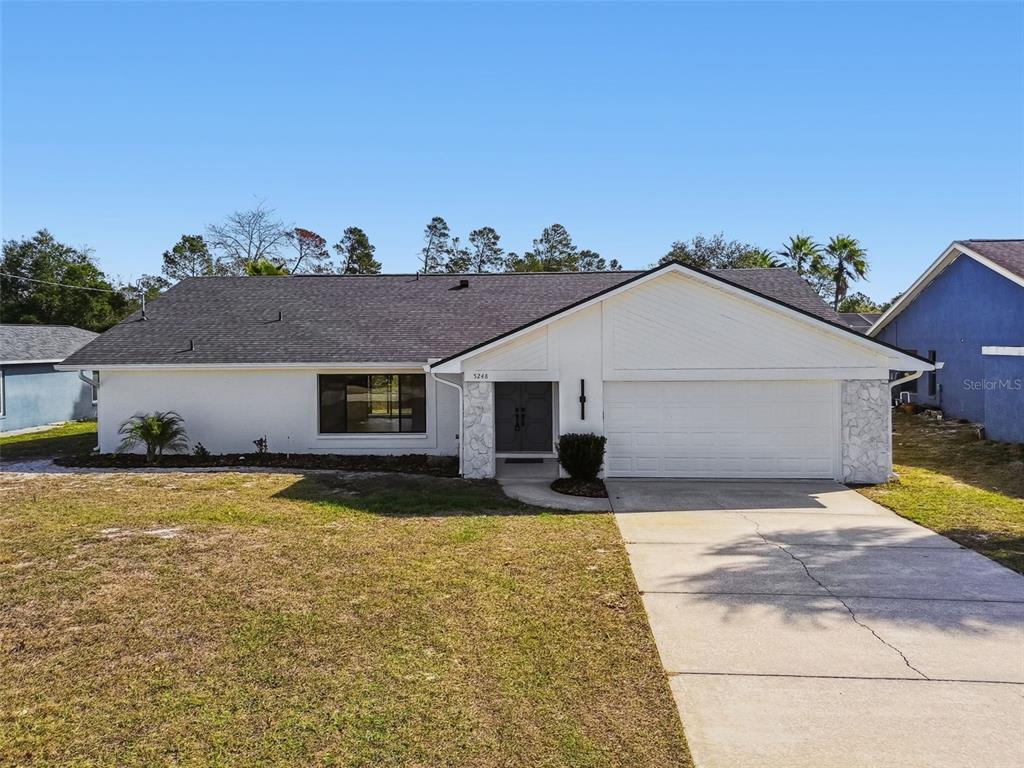 5248 Frost Road Spring Hill, FL 34606 - Photo 61 of 70 a view of a house with a yard in the background