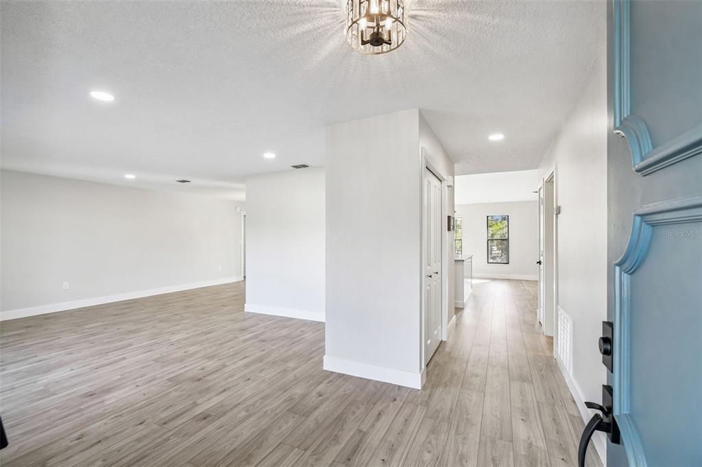 5248 Frost Road Spring Hill, FL 34606 - Photo 8 of 70 a view of a hallway with wooden floor
