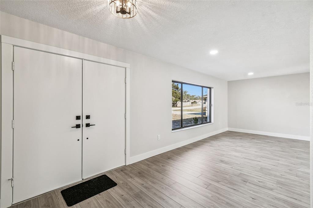 5248 Frost Road Spring Hill, FL 34606 - Photo 9 of 70 wooden floor in an empty room with a window