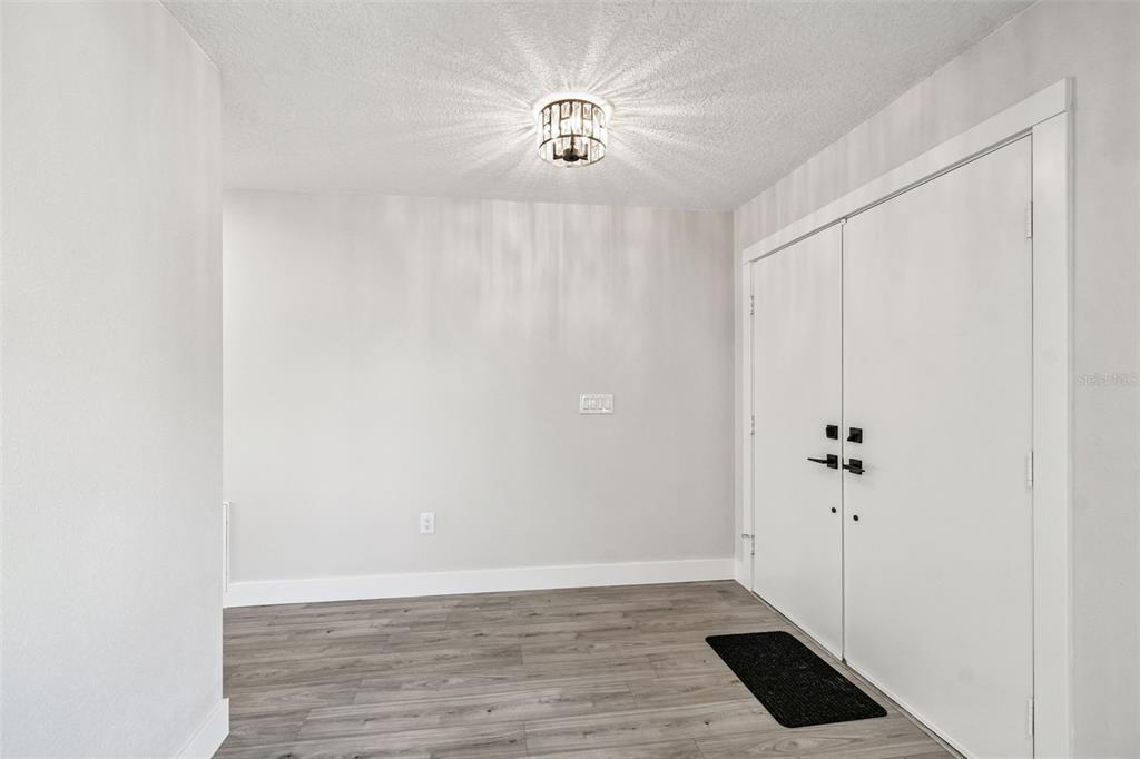 5248 Frost Road Spring Hill, FL 34606 - Photo 10 of 70 a view of an entryway with wooden floor