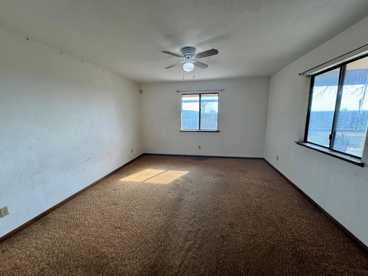 17617 West Belmont Avenue Kerman, CA 93630 - Photo 19 of 25 an empty room with windows and fan