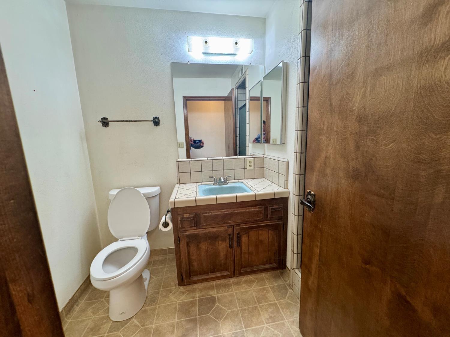 17617 West Belmont Avenue Kerman, CA 93630 - Photo 21 of 25 a bathroom with a granite countertop toilet a sink and a mirror