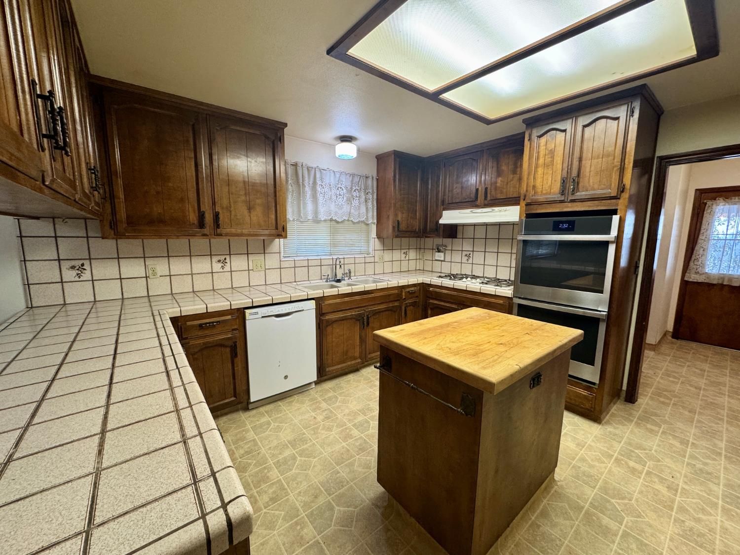 17617 West Belmont Avenue Kerman, CA 93630 - Photo 4 of 25 a kitchen with stainless steel appliances granite countertop a stove a sink dishwasher and a refrigerator