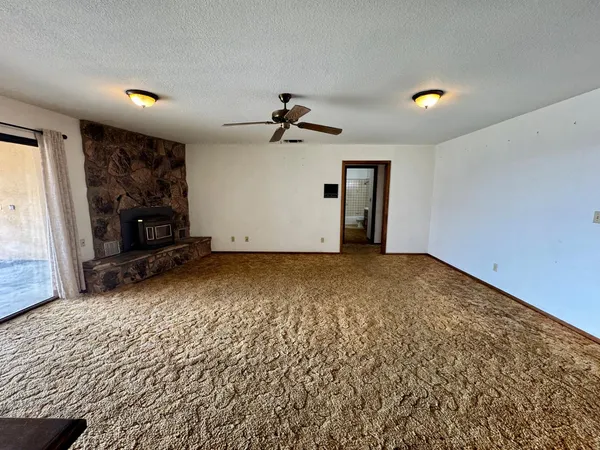 a view of room with window and a ceiling fan