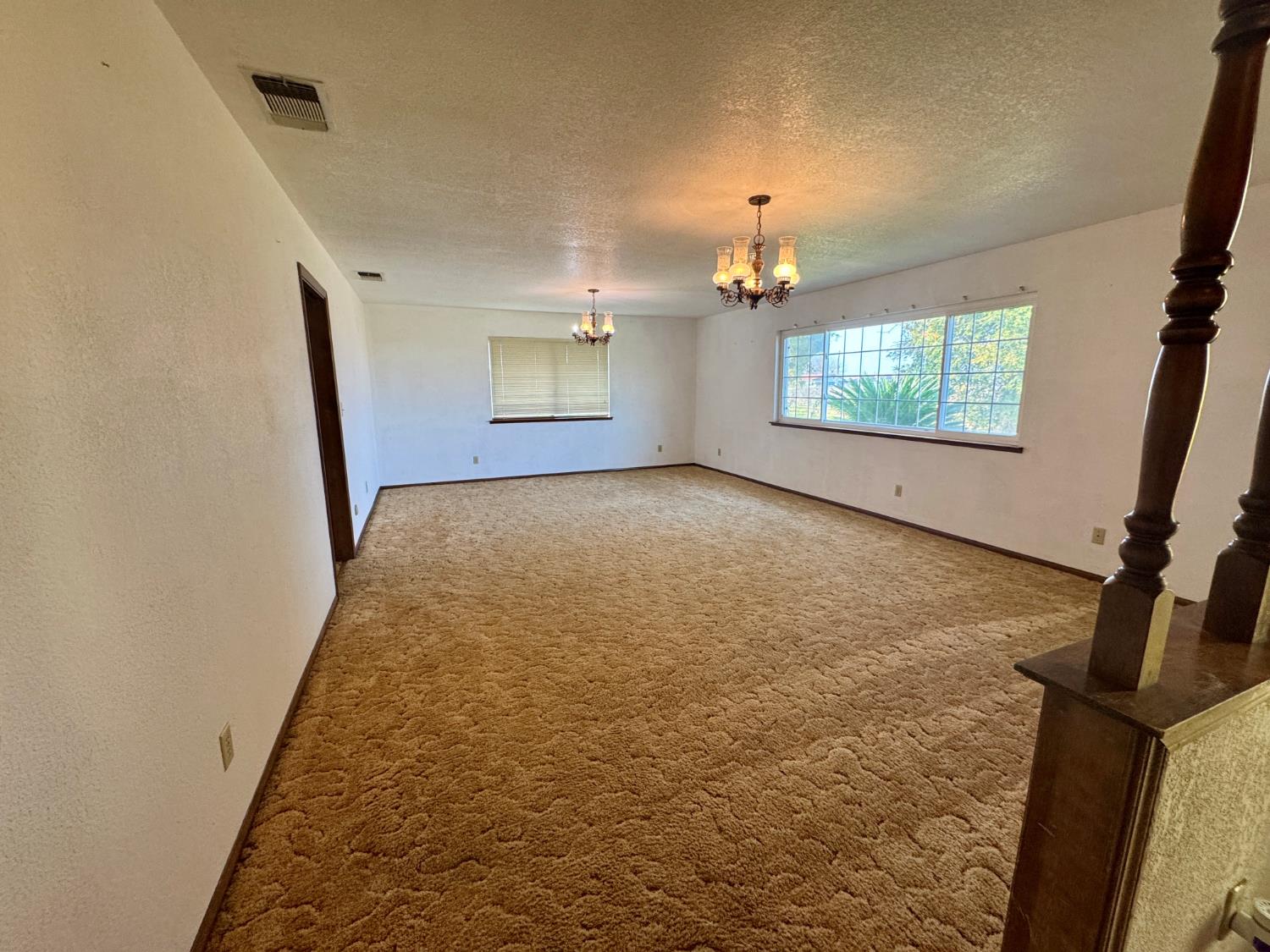 17617 West Belmont Avenue Kerman, CA 93630 - Photo 10 of 25 en empty room with windows and fireplace