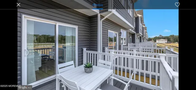 a view of a two room with wooden floor and windows