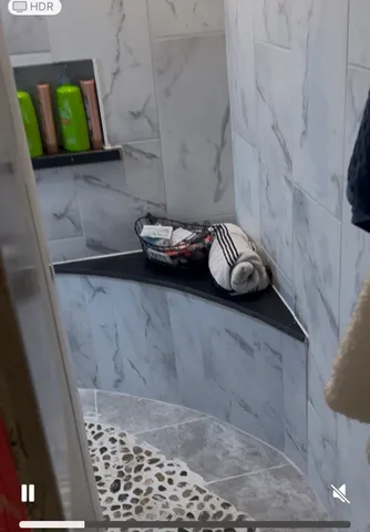 a bathroom with a shower and a sink