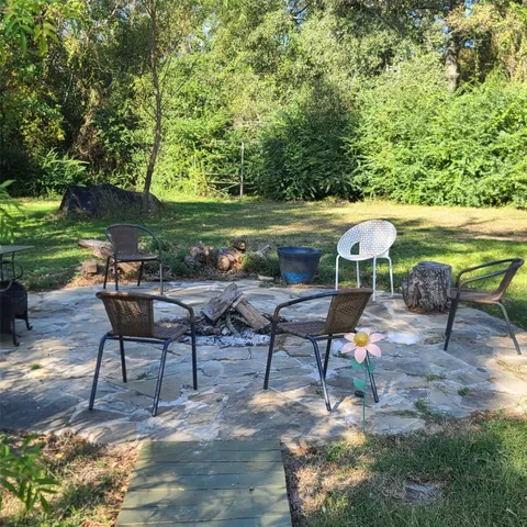 a view of a chairs and table in the patio