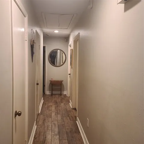 a view of a hallway with wooden floor
