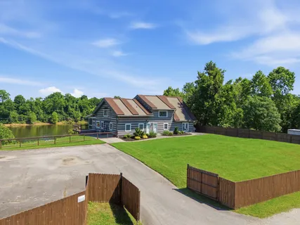 a view of yard with swimming pool and green space