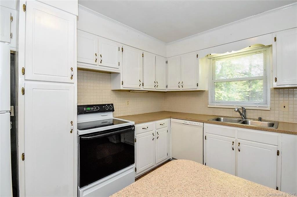 388 Shinnville Road Mooresville, NC 28115 - Photo 5 of 15 a kitchen with white cabinets appliances a sink and a window