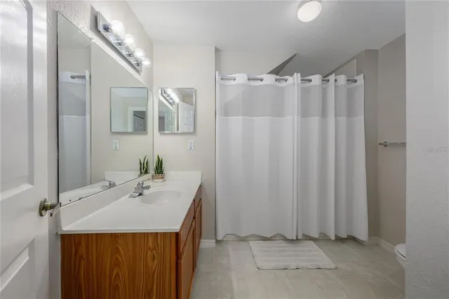 a bathroom with a sink a mirror and a shower