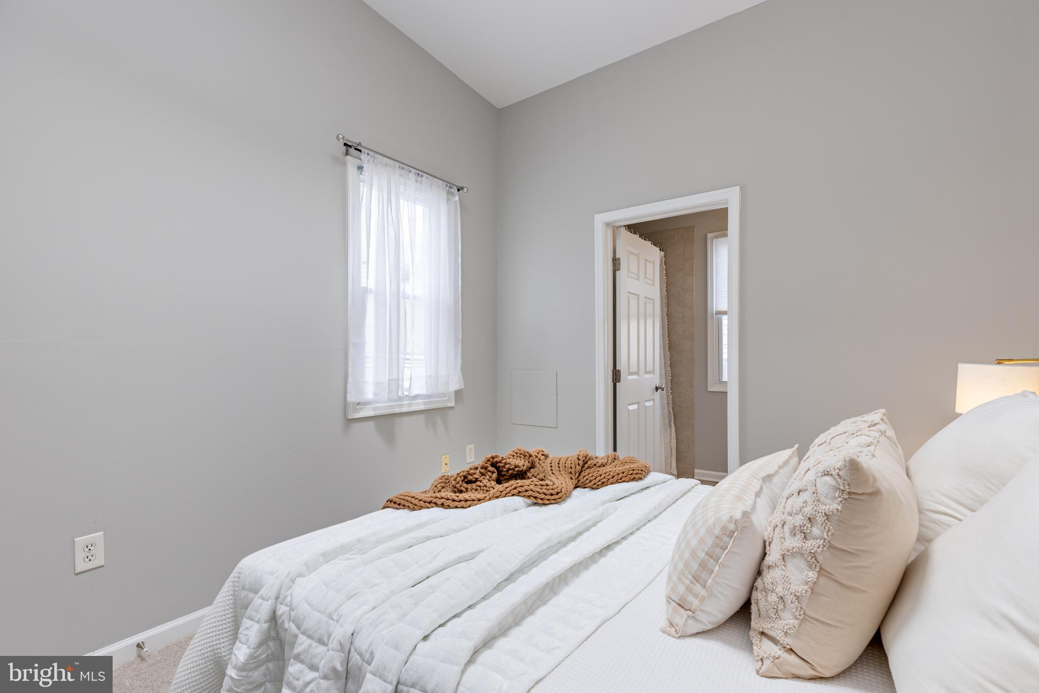 305 South Castle Street Baltimore, MD 21231 - Photo 10 of 28 a bedroom with a bed and a window