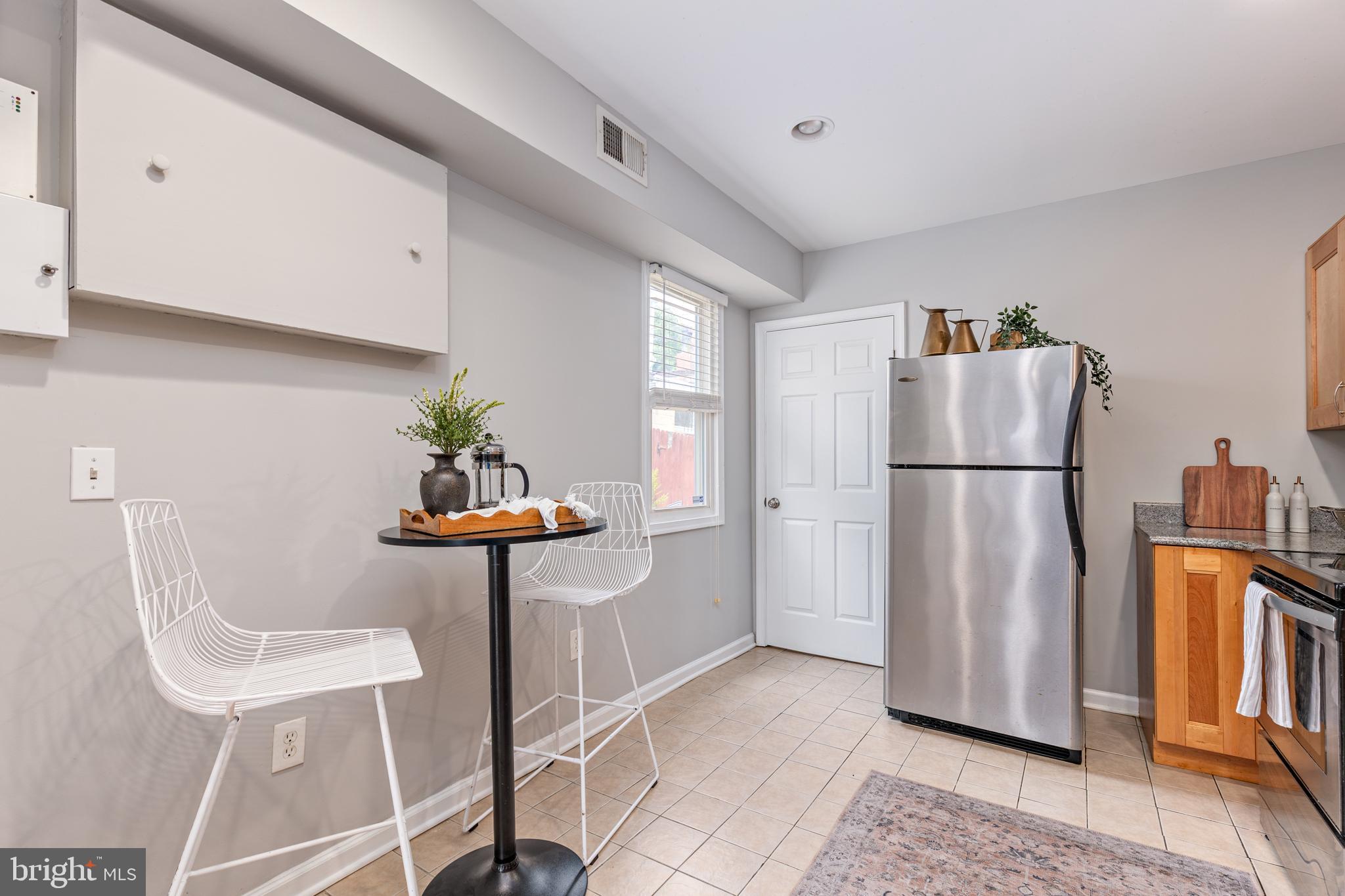 305 South Castle Street Baltimore, MD 21231 - Photo 7 of 28 a kitchen with stainless steel appliances granite countertop a refrigerator and a stove