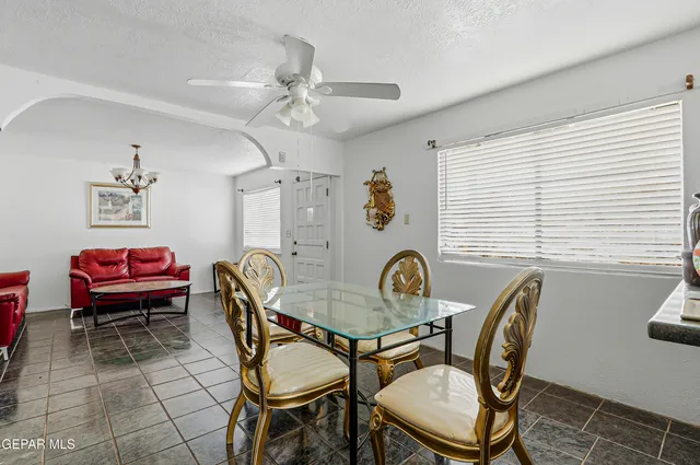 a dining room with furniture and window