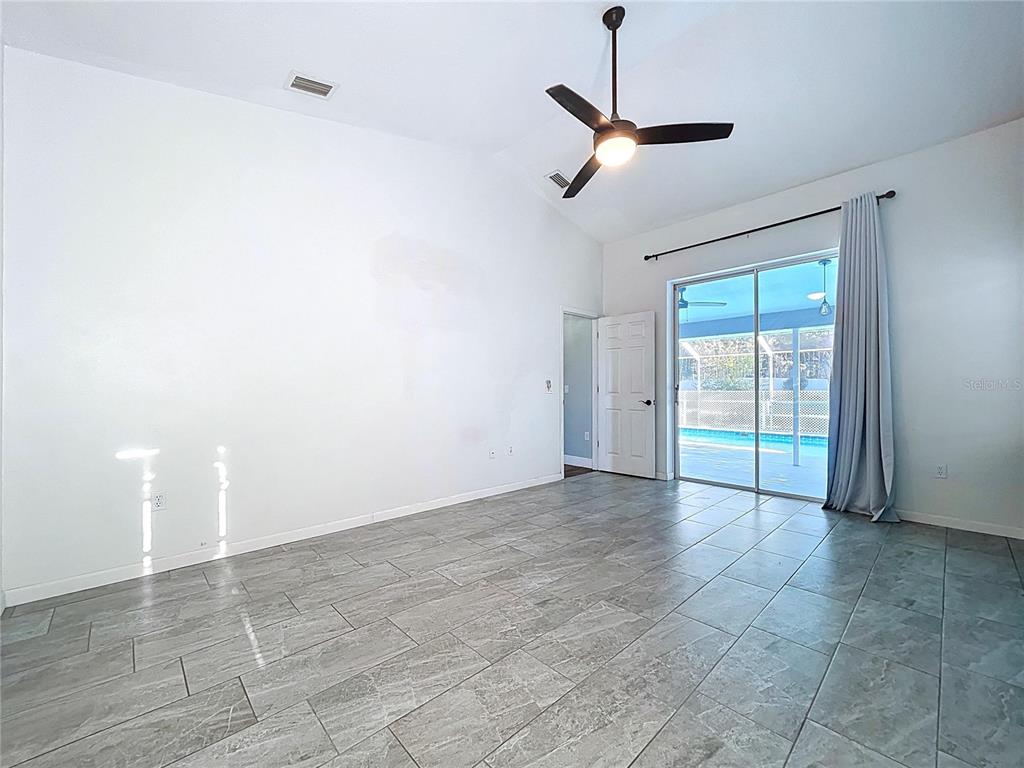 18812 Bascomb Lane Hudson, FL 34667 - Photo 49 of 57 a view of a livingroom with a ceiling fan and window