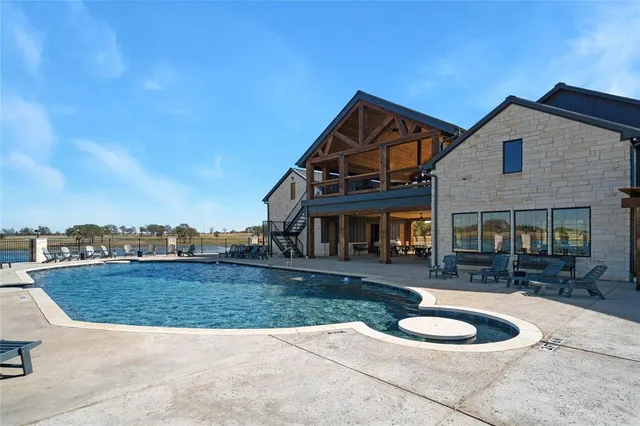a view of swimming pool with outdoor seating and city view