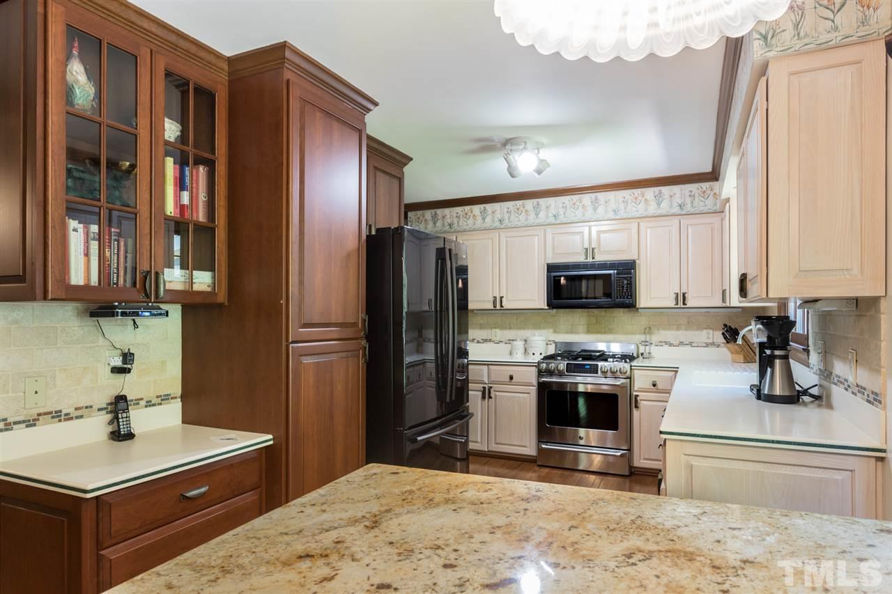 1812 Albacore Lane Raleigh, NC 27612 - Photo 11 of 30 a kitchen with stainless steel appliances granite countertop a sink stove and refrigerator