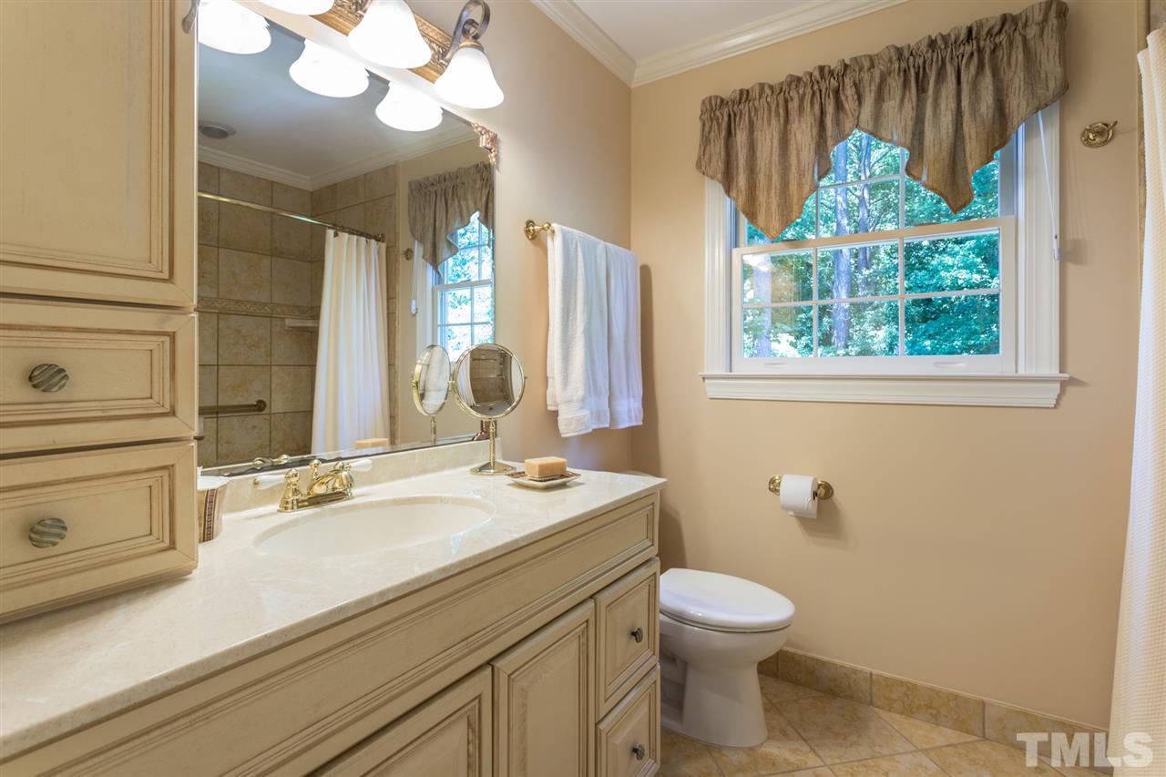 1812 Albacore Lane Raleigh, NC 27612 - Photo 16 of 30 a bathroom with a sink a toilet and a mirror