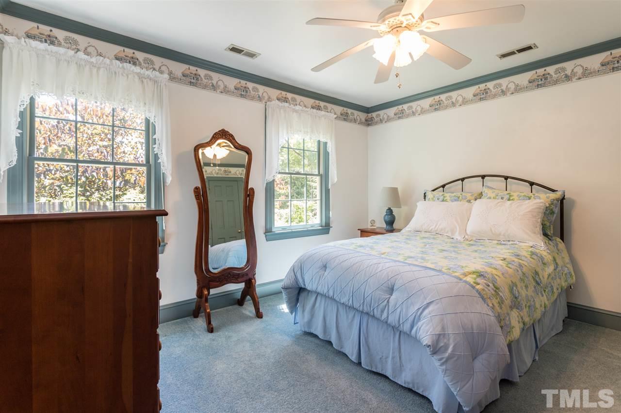 1812 Albacore Lane Raleigh, NC 27612 - Photo 17 of 30 a bedroom with a bed mirror and window