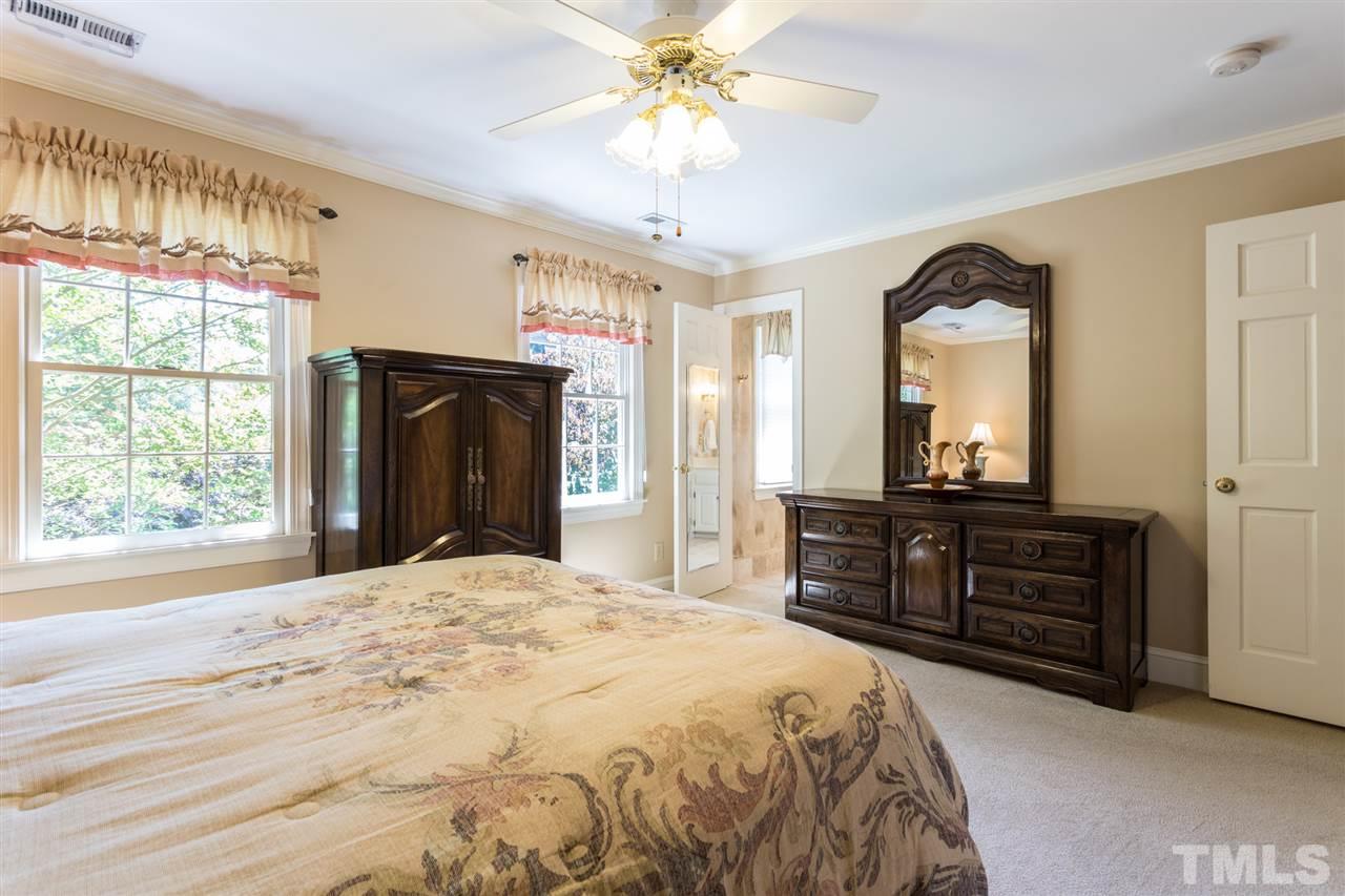 1812 Albacore Lane Raleigh, NC 27612 - Photo 24 of 30 a bedroom with a bed and a dresser with mirror