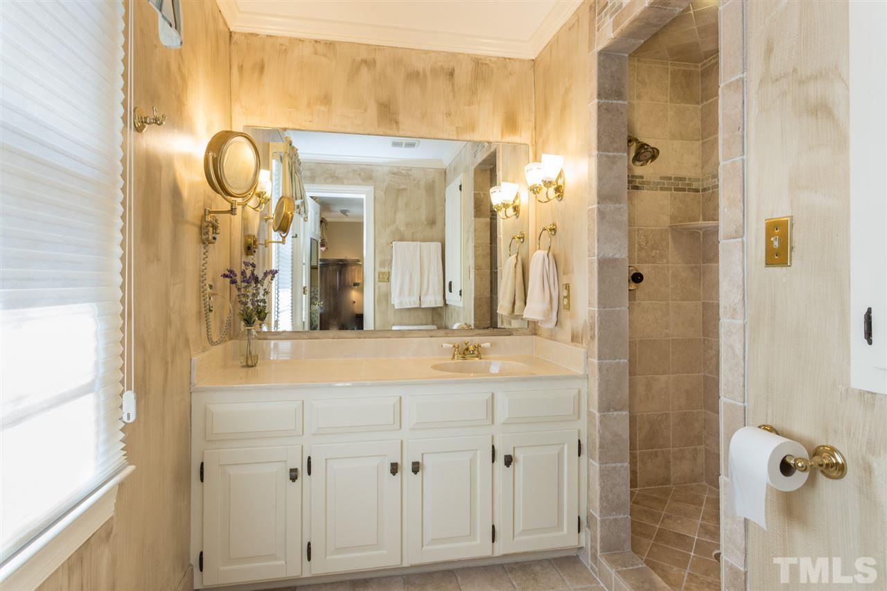1812 Albacore Lane Raleigh, NC 27612 - Photo 25 of 30 a bathroom with a mirror and a shower