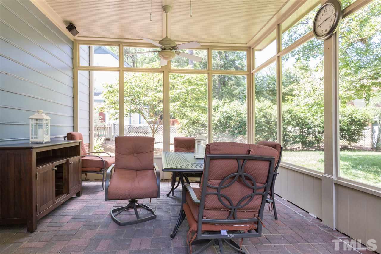 1812 Albacore Lane Raleigh, NC 27612 - Photo 27 of 30 a dining room with furniture water view and a floor to ceiling window