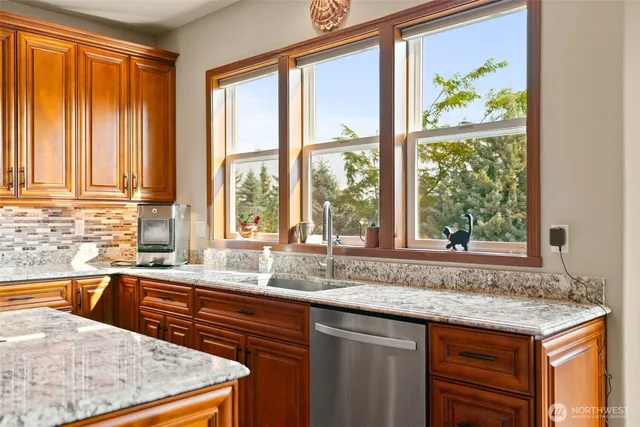 a kitchen with granite countertop a sink and a window