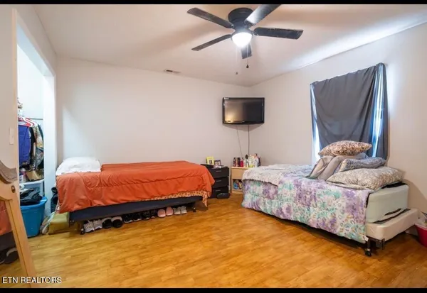 a bedroom with bed and a flat screen tv