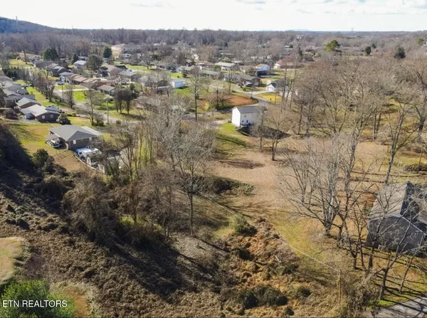 an aerial view of residential houses with city view