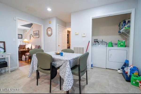 a view of a dining room with furniture and a potted plant